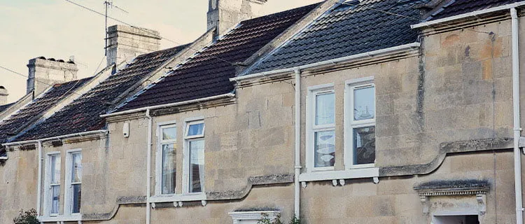 Landscape image of top level of three houses and windows.