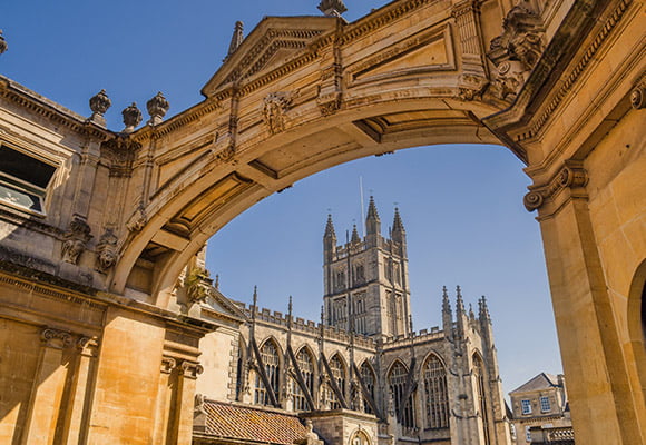 Palladian Archway in Bath City centre with Abbey in the background